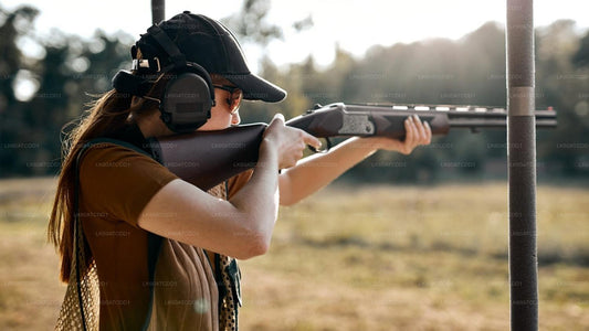 Person holding a rifle in an outdoor setting