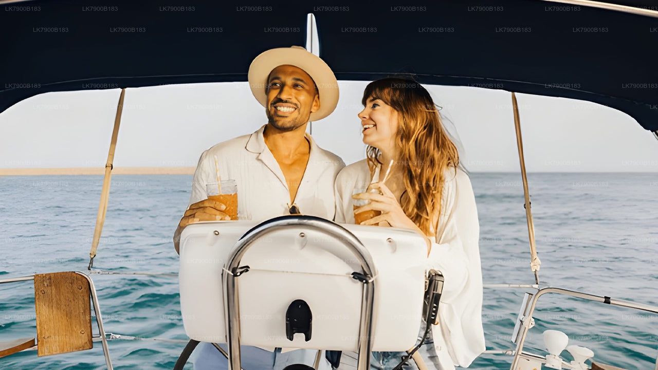 Man and woman on a sailboat holding drinks with a scenic ocean background