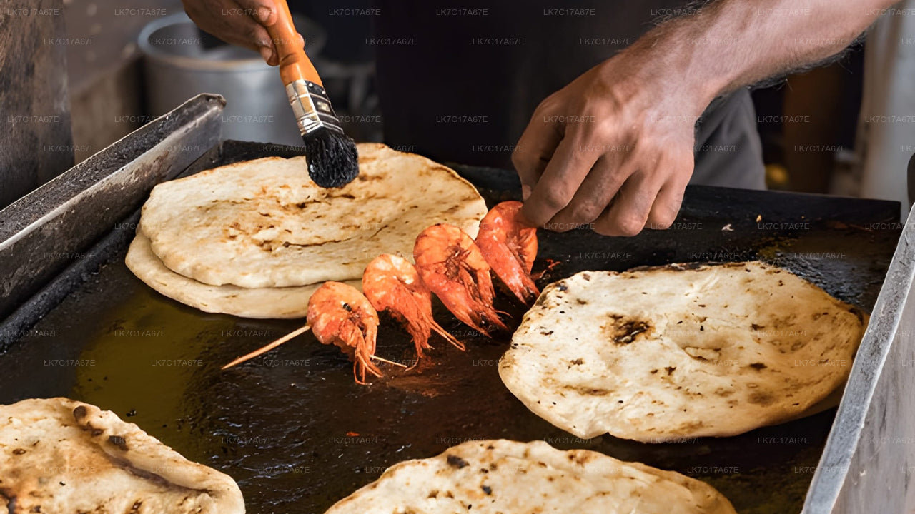 Person cooking prawns on a grill with flatbreads